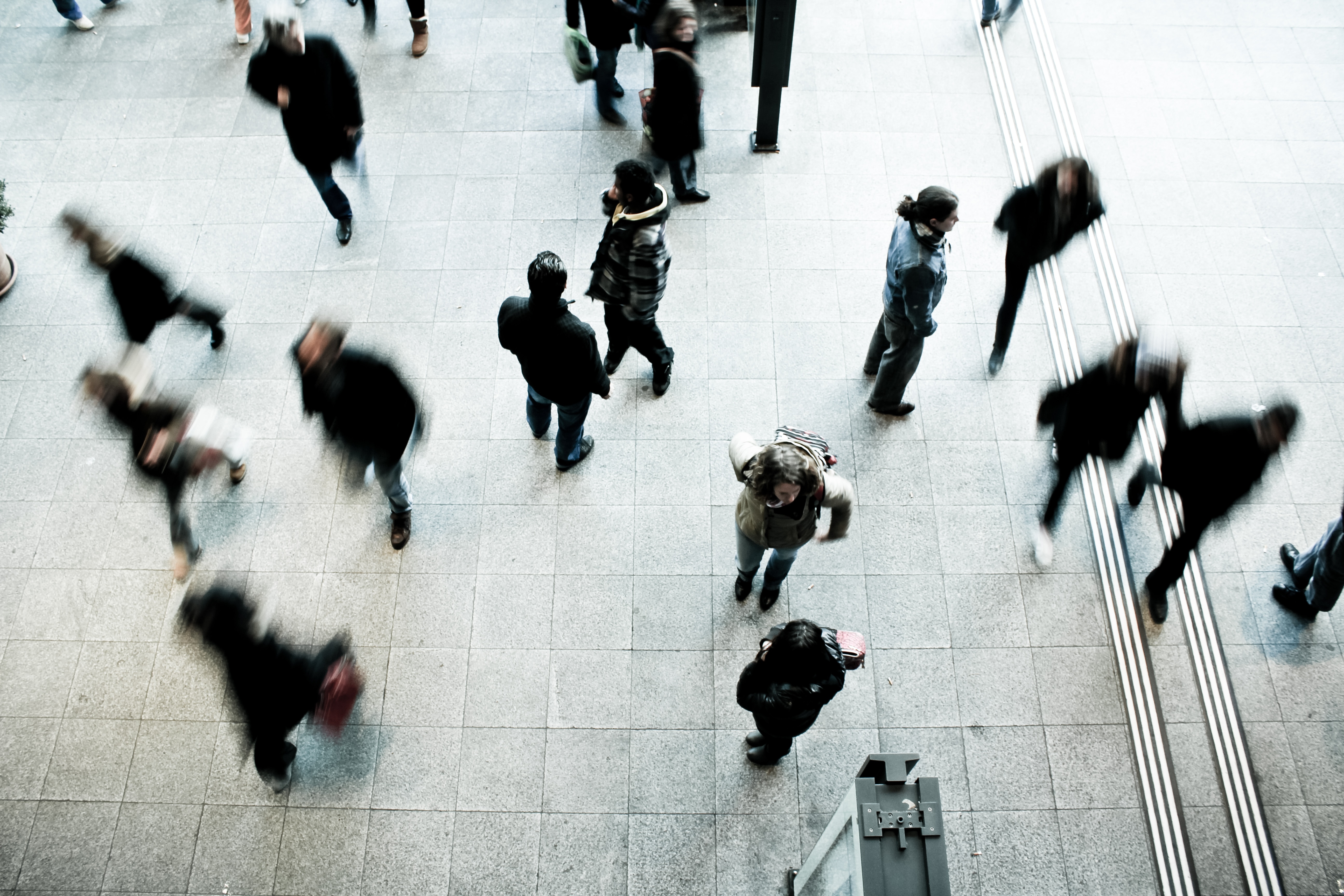 A photo of people walking busily